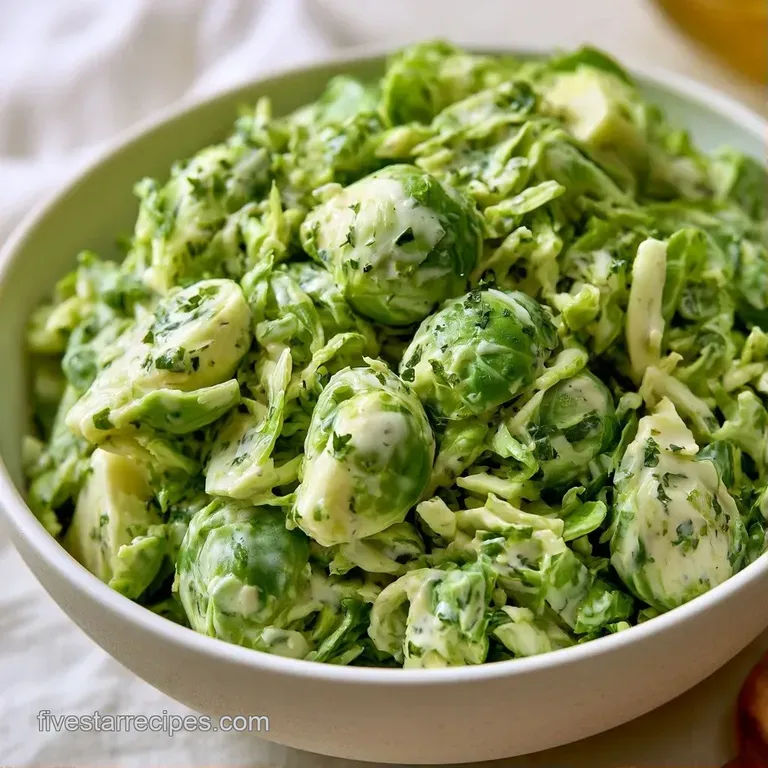 Bright green roasted sprouts tossed in creamy dressing, topped with gold croutons and parmesan curls on white ceramic.