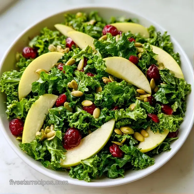 Bright green curly kale tossed with toasted seeds in a ceramic bowl, garnished with thin slices of red onion.