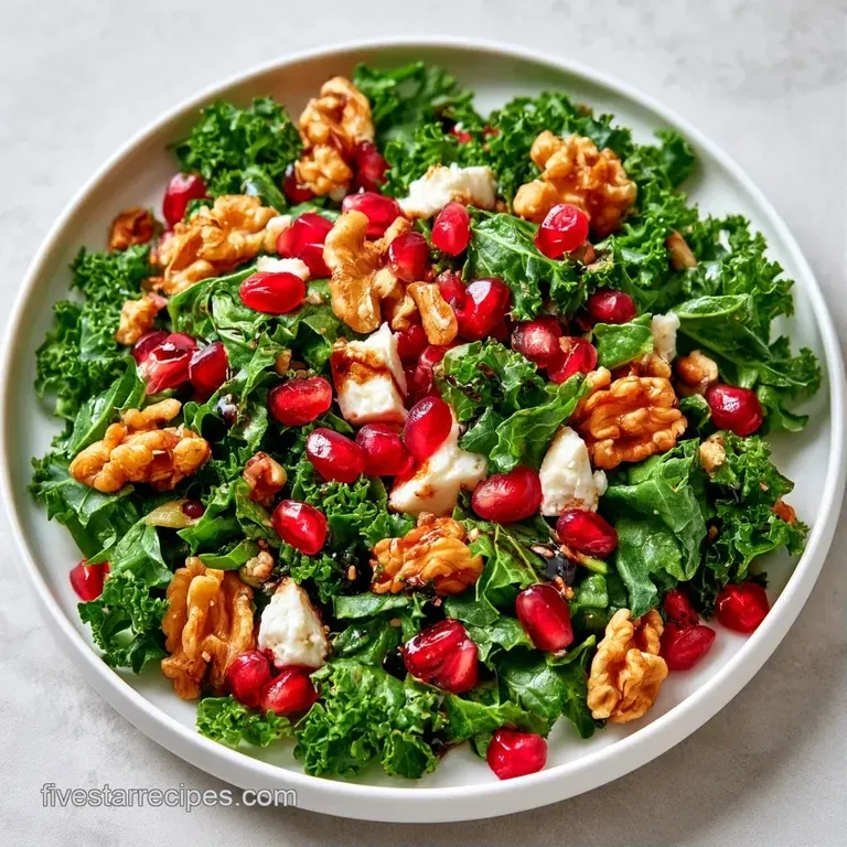 Bright green curly leaves topped with sparkling ruby pomegranate seeds and toasted almonds in a white ceramic bowl.